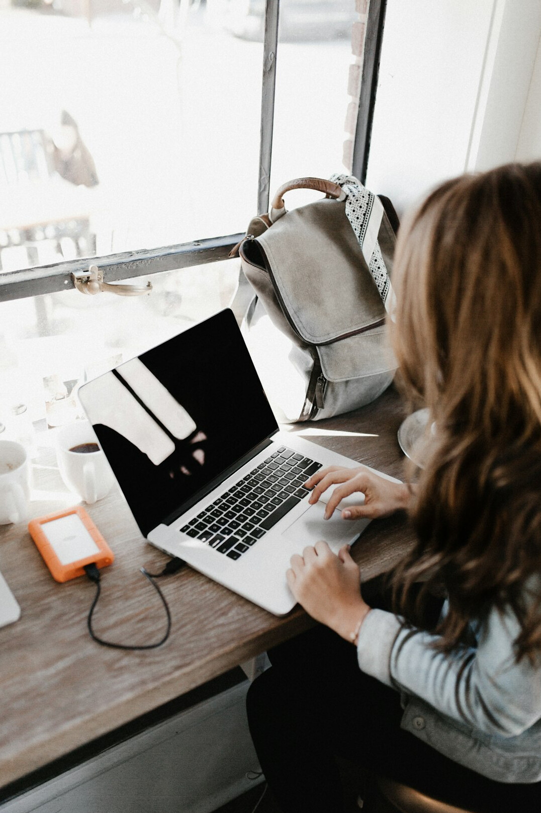 author typing on laptop