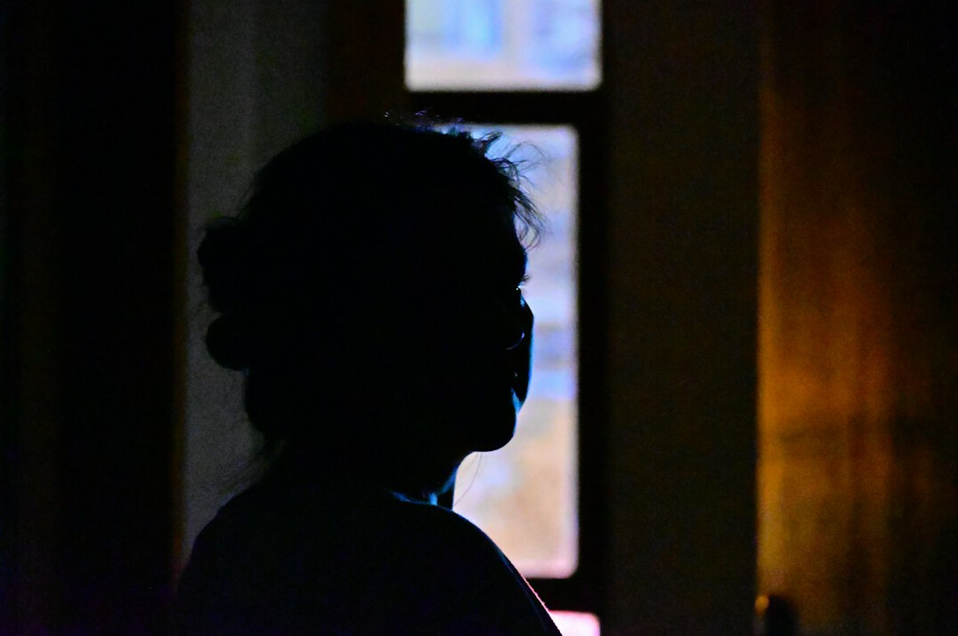 shadowy figure in dark room